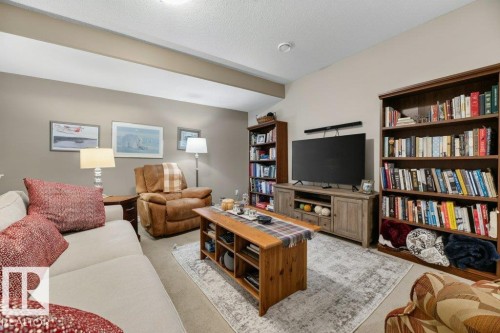Living area featuring vaulted ceilings with exposed beam, recessed lighting, and carpet flooring - 5528 43 Street, Lamont, AB 