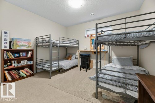 Carpeted interior room featuring neutral wall tones, a built-in window, and a ceiling-mounted light fixture - 5528 43 Street, Lamont, AB 
