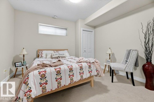 Neutral wall paint and carpeting, featuring a window and bi-fold closet doors - 5528 43 Street, Lamont, AB 