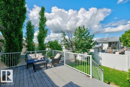 Expansive outdoor deck featuring wood-finish flooring and white railings - 5528 43 Street, Lamont, AB 