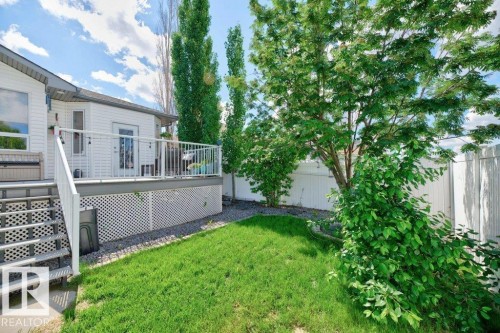 Exterior features include white siding, a raised deck with white railings, and a lattice skirt - 5528 43 Street, Lamont, AB 