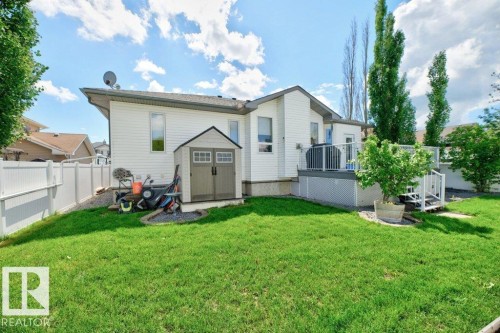 Expansive green lawn with a white privacy fence - 5528 43 Street, Lamont, AB 