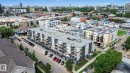 Contemporary multi-story residential building featuring private balconies, integrated covered parking, and a flat roofline - 413 10116 80 Avenue, Edmonton, AB 
