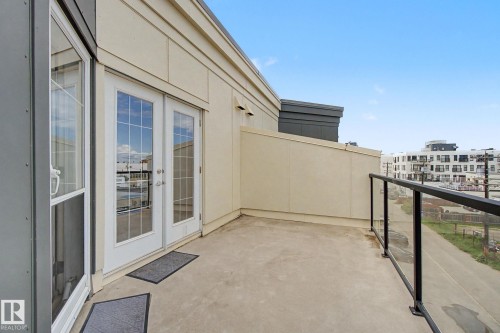 Private outdoor balcony featuring a concrete surface and a glass-paneled railing - 413 10116 80 Avenue, Edmonton, AB 