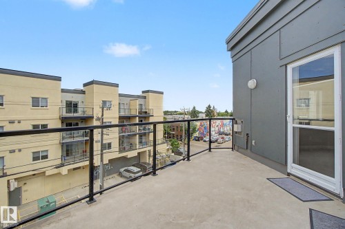 Expansive concrete balcony with a black and glass railing system - 413 10116 80 Avenue, Edmonton, AB 