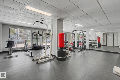 Fitness facility featuring recessed lighting, a mirrored wall, and durable rubber flooring - 413 10116 80 Avenue, Edmonton, AB 
