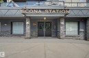 "SCONA STATION" building entrance featuring a stone facade, double entry doors, a large overhead awning, and glass-paneled balconies on upper levels - 413 10116 80 Avenue, Edmonton, AB 