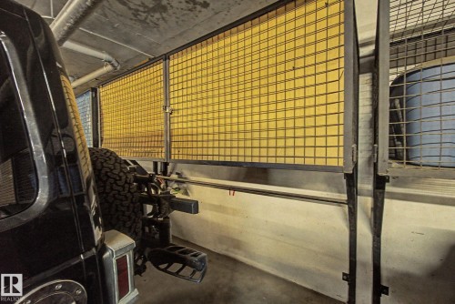 Secure storage cage featuring a yellow grid panel and a robust metal frame - 413 10116 80 Avenue, Edmonton, AB 