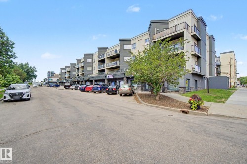 Multi-story building featuring contemporary architecture with balconies and ground-level commercial units - 413 10116 80 Avenue, Edmonton, AB 