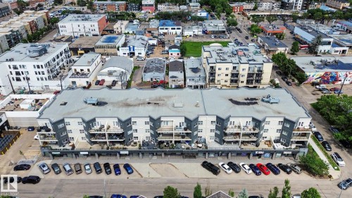 Multi-story building featuring ground-level retail spaces and residential units above - 413 10116 80 Avenue, Edmonton, AB 