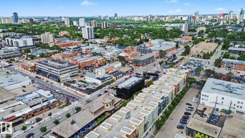 Urban landscape featuring a mix of commercial and residential buildings, multistory structures, and a clear sky - 413 10116 80 Avenue, Edmonton, AB 