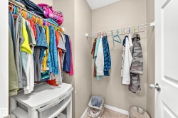 Walk-in closet featuring wire shelving and carpet flooring - 