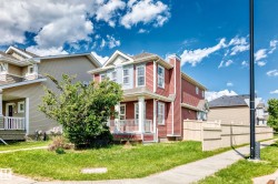 Red siding exterior with white trim accents and a covered front porch featuring white railings - 