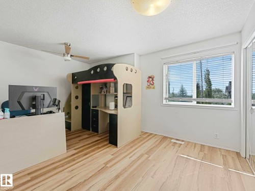 Light wood-finish flooring complements the neutral wall tones - 62 3075 Trelle Crescent Nw, Edmonton, AB - Indoor Photo Showing Other Room