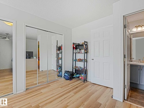 Light wood-finish flooring complements the bright white walls and trim - 62 3075 Trelle Crescent Nw, Edmonton, AB - Indoor