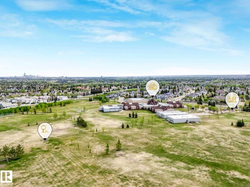 Expansive green space featuring scattered trees and a distant skyline - 62 3075 Trelle Crescent Nw, Edmonton, AB - Outdoor With View