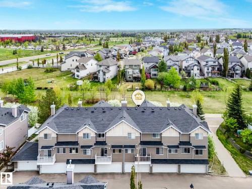 Townhome complex featuring multi-car garages, private balconies, and a pitched roofline - 62 3075 Trelle Crescent Nw, Edmonton, AB - Outdoor With Facade