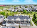 Townhome complex featuring multi-car garages, private balconies, and a pitched roofline - 62 3075 Trelle Crescent Nw, Edmonton, AB  - Outdoor With Facade 