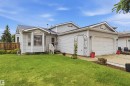Exterior featuring light gray siding and a dark shingled roof - 4428 11A Avenue, Edmonton, AB 
