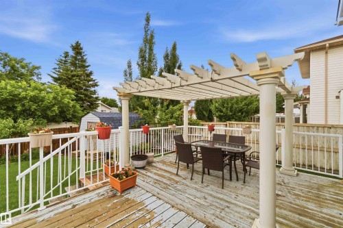 Expansive wood deck featuring a decorative pergola - 4428 11A Avenue, Edmonton, AB 