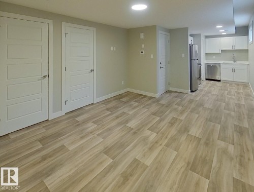 Open-concept room featuring wood-finish flooring, recessed lighting, and a neutral wall palette - #Basement 10923 159 St Nw, Edmonton, AB - Indoor Photo Showing Other Room