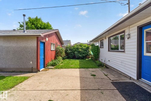 Expansive concrete patio area with a green lawn - 13431 109 Street, Edmonton, AB 