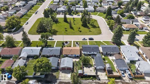 Residential neighborhood featuring a cul-de-sac with a central green space, mature trees, and paved roads - 13431 109 Street, Edmonton, AB 