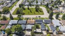 Residential neighborhood featuring a cul-de-sac with a central green space, mature trees, and paved roads - 13431 109 Street, Edmonton, AB 