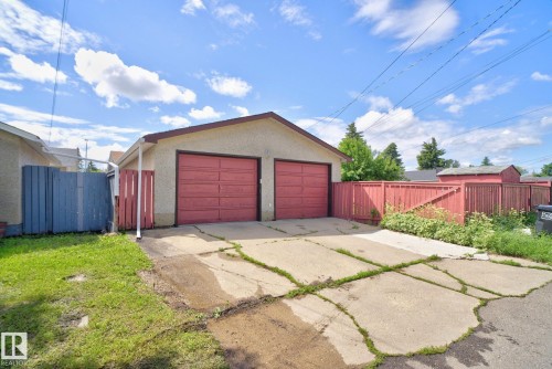 Two-car detached garage with red garage doors and a concrete drive - 13431 109 Street, Edmonton, AB 