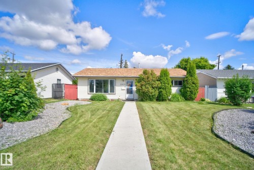 Cream siding exterior with a brown shingled roof - 13431 109 Street, Edmonton, AB 
