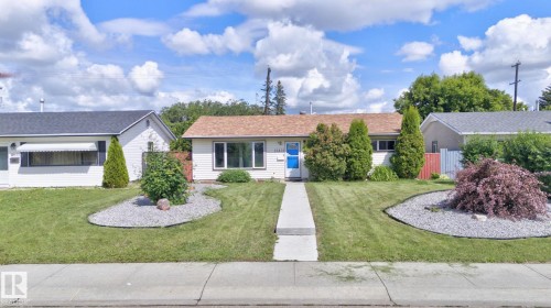 Single-story residence featuring a front lawn with a central concrete pathway, decorative gravel beds, and established landscaping - 13431 109 Street, Edmonton, AB 
