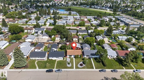 Detached residence featuring a light-colored exterior and a brown shingle roof - 13431 109 Street, Edmonton, AB 