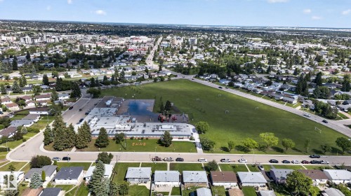 Aerial perspective of a residential neighborhood featuring a central school building and expansive green space - 13431 109 Street, Edmonton, AB 