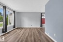 Interior room featuring wood-finish flooring, light grey walls, and white baseboards - 13431 109 Street, Edmonton, AB 