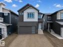 Contemporary two-story residence featuring a striking dark grey and light grey exterior - 8915 Mayday Way, Edmonton, AB 