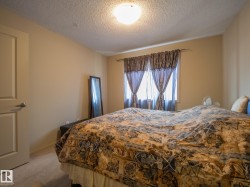 Bedroom with neutral wall color and light-colored carpet flooring - 