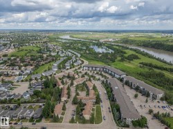 Aerial perspective showcasing a residential community with multi-story apartment buildings, townhouses, and single-family homes - 