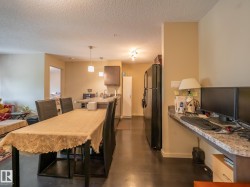 Open-concept living area with dark wood-finish flooring - 