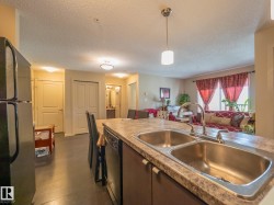 Kitchen island with a double stainless steel sink and a gooseneck faucet - 