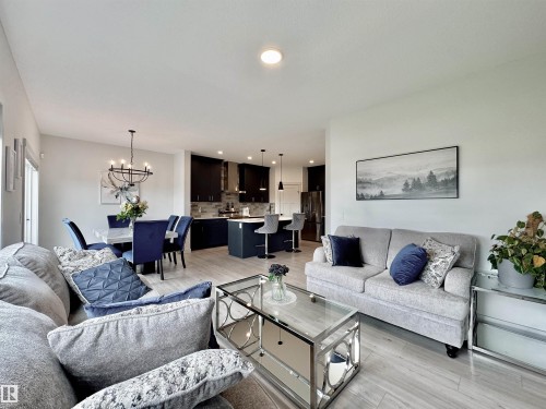 Open-concept living space featuring wood-finish flooring - 33 Sumac Close, Fort Saskatchewan, AB 