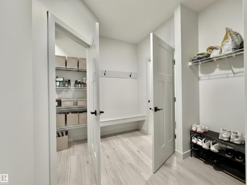 Utility room featuring light wood-finish flooring and white walls - 33 Sumac Close, Fort Saskatchewan, AB 
