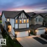 Modern Tudor-inspired exterior with white siding, dark trim, and a prominent front gable - 33 Sumac Close, Fort Saskatchewan, AB 