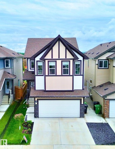Two-story home with gabled roofline and architectural trim details - 33 Sumac Close, Fort Saskatchewan, AB 