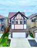 Two-story home with gabled roofline and architectural trim details - 33 Sumac Close, Fort Saskatchewan, AB 