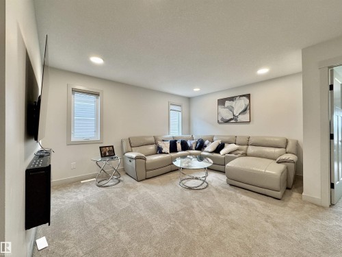 Carpeted living area featuring recessed lighting, light-colored walls, and white trim - 33 Sumac Close, Fort Saskatchewan, AB 