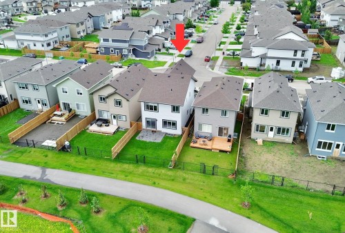 Rear elevation of a two-story residence featuring a private backyard with a wood deck - 33 Sumac Close, Fort Saskatchewan, AB 
