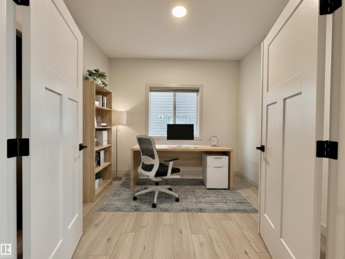 Room featuring light wood-finish flooring, a single window with blinds, and white interior doors with black hardware - 33 Sumac Close, Fort Saskatchewan, AB 