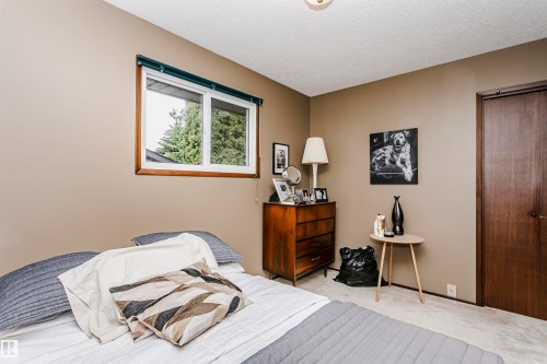 Neutral-toned walls complement the white window trim and dark wood door - 14231 80 Street, Edmonton, AB 