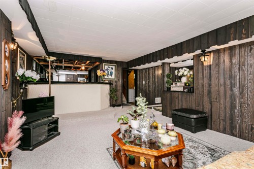 Interior space featuring wood-finish paneling and light-colored carpeting - 14231 80 Street, Edmonton, AB 