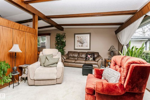 Wood-paneled accent wall with exposed ceiling beams and recessed lighting - 14231 80 Street, Edmonton, AB 